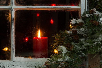 Glowing Christmas candle in frosted home window - Powered by Adobe