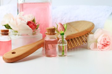 Fototapeta na wymiar Rose water botanical hair products treatment, vials jars comb towel tonic home spa setting, feminine secret, blank space, soft delicate focus