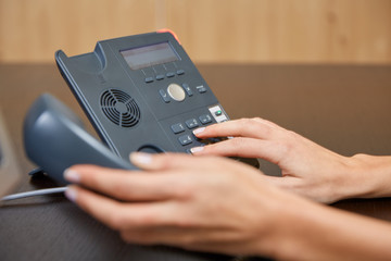 Woman dialing on a telephone