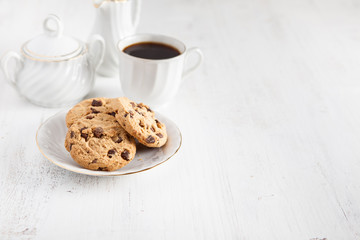 Coffee and chocolate chip cookies on the white table
