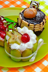 Three cake with berries on green plate
