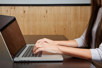 Woman typing on a laptop computer