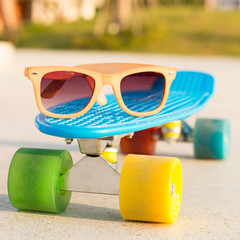 light blue longboard penny board with multicolored wheels ready