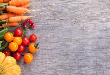 Autumn vegetables background: tomatoes, carrots, pumpkin, runner beans, chilies