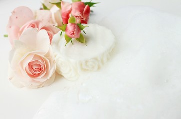 Obraz na płótnie Canvas Handmade botanical soap fresh rose flowers soft natural foam healthy skin cleansing soft delicate focus