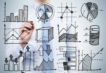A person in formal shirt and tie is drawing some graphs on the glass screen. The concept of financial analyst duties.