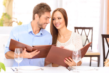 Nice couple sitting at the table 