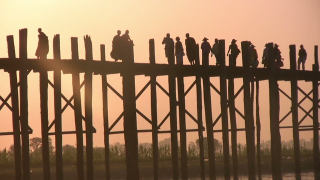 U Bein Bridge at sunset with people crossing Ayeyarwady River, Mandalay, Myanmar
