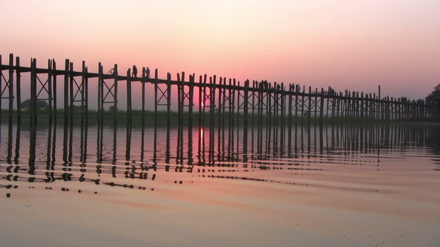 U Bein Bridge at sunset with people crossing Ayeyarwady River, Mandalay, Myanmar
