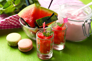Watermelon ice cream in glass jars  on color wooden background