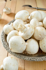 raw champignons on wooden background