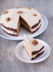 Homemade coffee and walnut cake on the dark wooden table