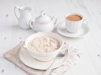 healthy breakfast: oats porridge with coffee on the table