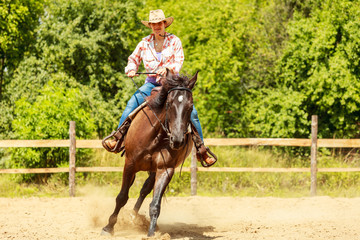 Western cowgirl woman riding horse. Sport activity