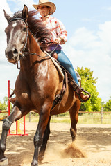 Fototapeta na wymiar Western cowgirl woman riding horse. Sport activity