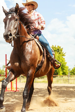 Western cowgirl woman riding horse. Sport activity