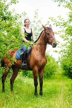 Woman jockey training riding horse. Sport activity