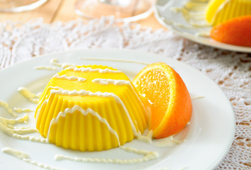 custard pudding with vanilla sauce and orange