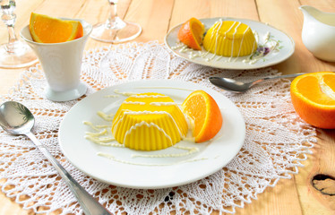 custard pudding with vanilla sauce and orange