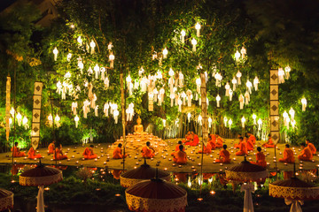 Monks prayed under tree in Loy Krathong Day.