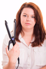 Fototapeta premium Woman holds hair straightener