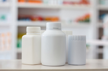 many medicine bottle with blur shelves of drug in the pharmacy d
