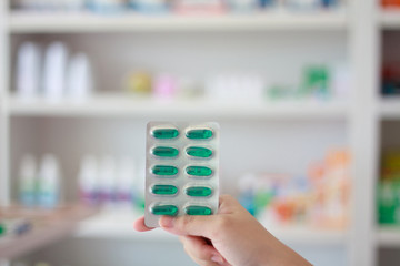 Close up of female doctor hands holding pills