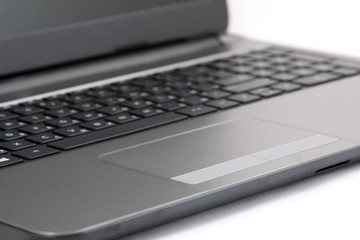 close-up touchpad and keyboard of the notebook on white