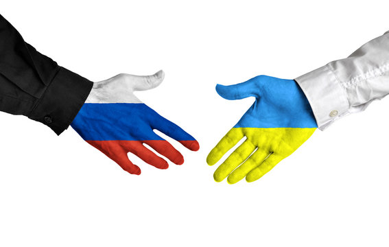 Russia and Ukraine leaders shaking hands on a deal agreement