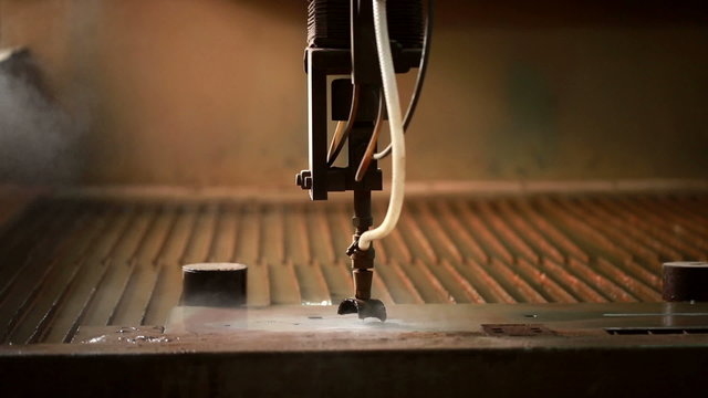 Cutting metal by using of water jets and sand