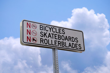 A NO BICYCLES NO SKATEBOARDS NO ROLLERBLADES sign with a sky background. An OUTLINE PATH IS INCLUDED so the sign can be dropped into any setting very easily.