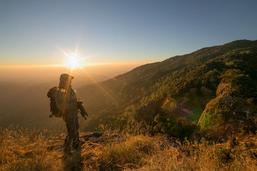 photographer taking picture of landscape during sunset