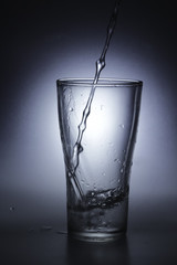 pouring cold water into a glass