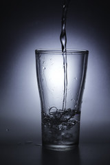 pouring cold water into a glass