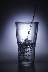 pouring cold water into a glass