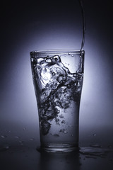 pouring cold water into a glass