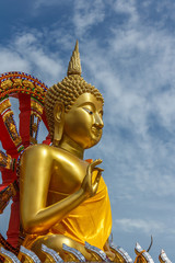 Golden Buddha and blue sky.