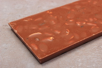 Chocolate with nuts and raisins on cement structure