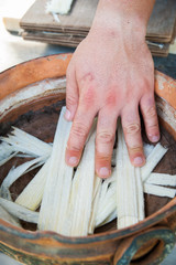 The working of Papyrus: artisan dunking in the water with antioxidant thin strips obtained from the...