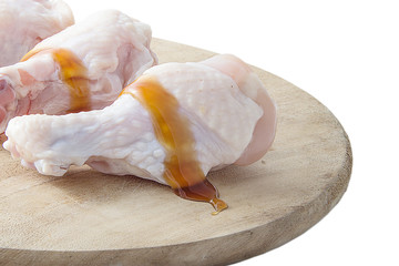 Fototapeta na wymiar raw chicken legs on wooden cutting boards on white background