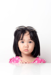 Little girl portrait seating at the table