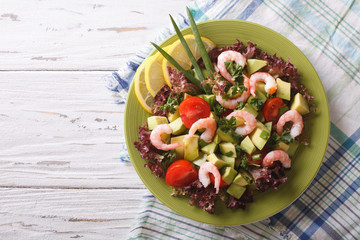 salad with avocado, shrimp and vegetables. horizontal top view
