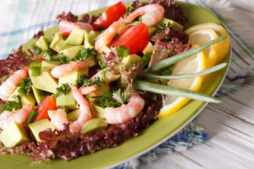 avocado salad with shrimp close-up on a plate. Horizontal
