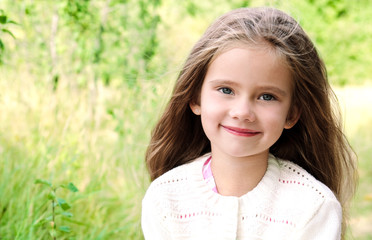 Portrait of smiling cute little girl in summer day