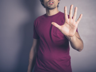 Young man saying stop