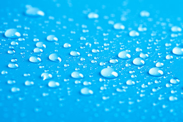 Drops of water on a color background. Blue. Shallow depth of fie