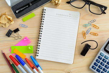 Blank notebook with office supply on desk