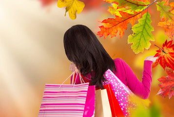 Young happy woman with shopping bags, autumn season.