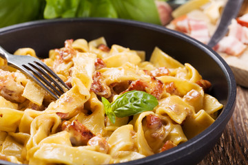 Pasta Carbonara with bacon, basil and cheese