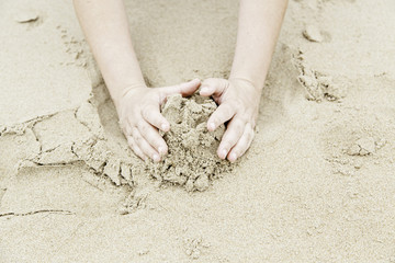 Playing with hands in the sand
